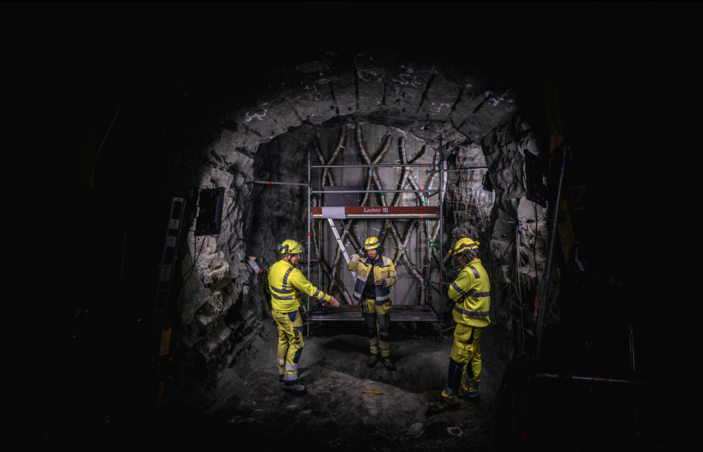 Workers with helmets down in a mine.
